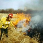 Firefighter operating a pump can