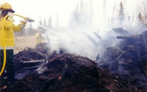 Firefighters working slash pile