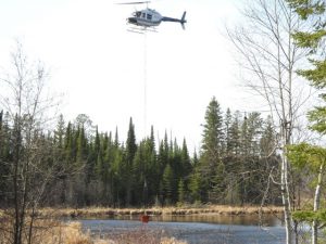 Helicopter dipping water