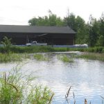 Sandbags about three feet high protect Hudrliks Carpet in Aitkin, MN during the 2012 floods.