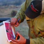 firefighter-checks-map-during-lake-hattie-fire-2016