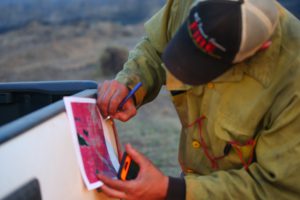 firefighter-checks-map-during-lake-hattie-fire-2016