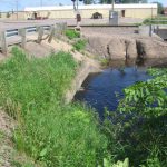 Water in swollen river reaches the bottom of the Ripple River Bridge near a railroad crossing in Aitkin, MN.