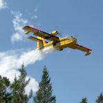 green-valley-fire-cl215-dropping-water-over-pine-trees