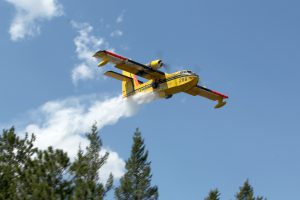 green-valley-fire-cl215-dropping-water-over-pine-trees