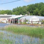 Sandbags keep a flooded street near a flower shop in Aitkin, MN in check.