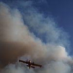 Wildfire-green-valley-2013-cl215-water-scooper-flies-through-smoke