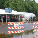 Flood waters breach dikes and sandbags around a local business in Aitkin, MN, 2012.