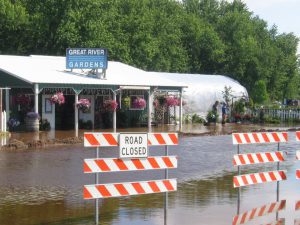 Flood waters breach dikes and sandbags around a local business in Aitkin, MN, 2012.