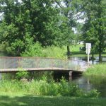 Flooding occurs near a foot bridge in Aitkin City Park, 2012.