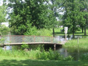 Flooding occurs near a foot bridge in Aitkin City Park, 2012.