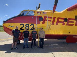 Crew of the CL 415 EAF stand next to the aircraft