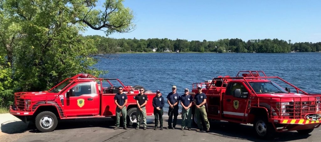 Two New Jersey Forest Fire Service Engines and crew near lake