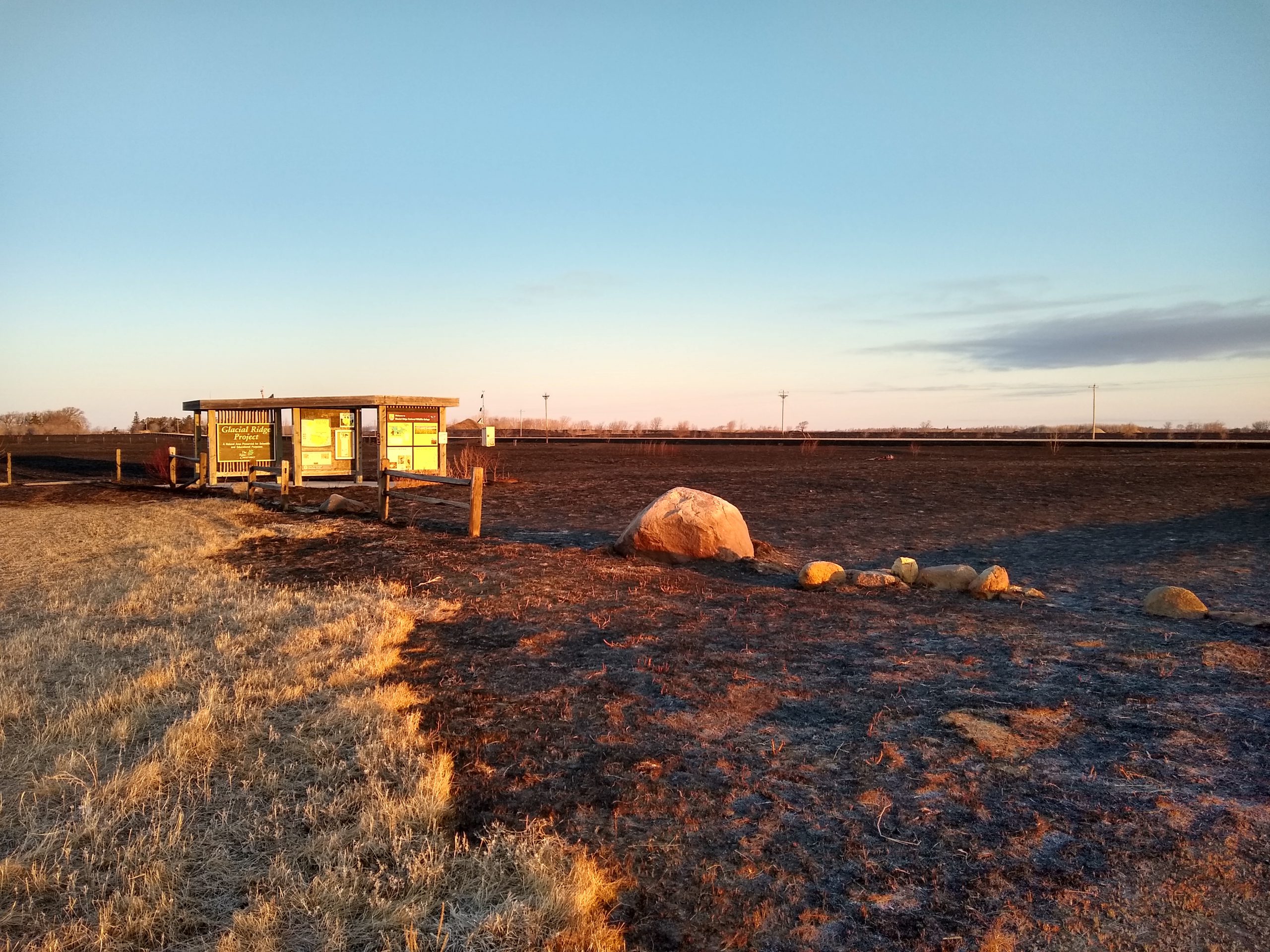 Kiosks stand between burned and unburned field.