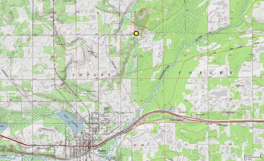 topographic map with yellow dot and orange boundary line