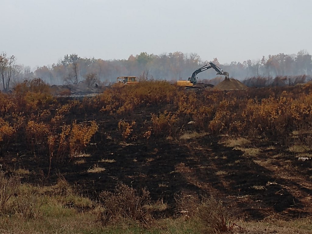 Heavy equipment and burned vegetation