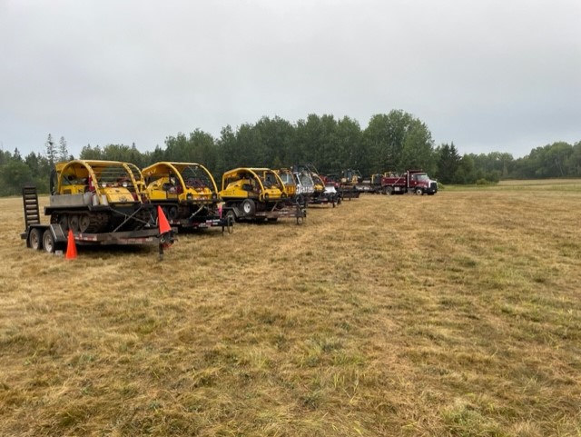 A line of J5s and other machinery in a field.
