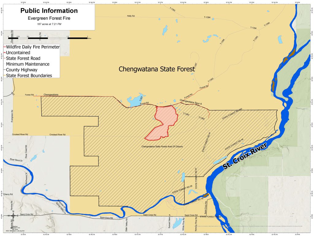 A map with light orange shading defining the state forest, blue defining water bodies, side hash lines defining the closure area, and the fire area shaded pink and outlined in red. 