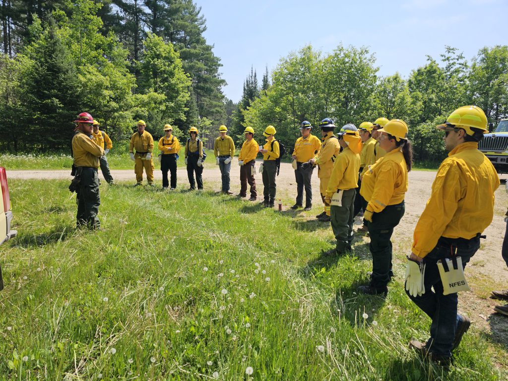 Wildfire Academy students standing in a semicircle around an instructor