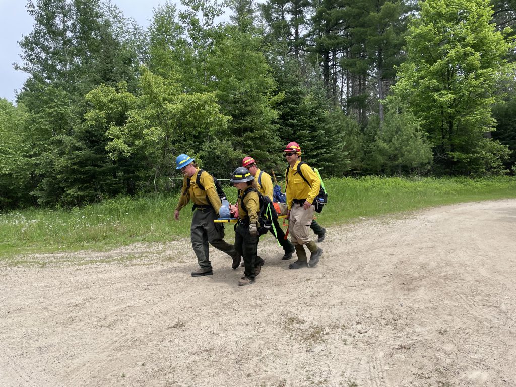 Wildfire Academy students carrying stretcher