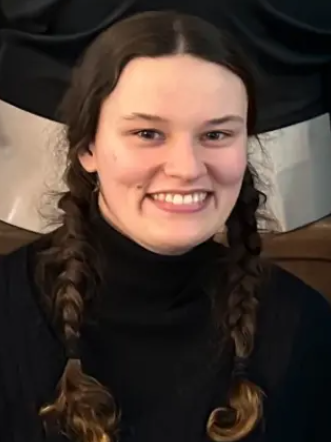 Headshot image of a woman wearing a dark shirt. 